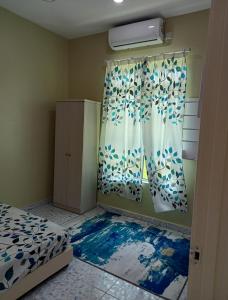 1 dormitorio con cama y ventana en Minimalist Homestay D Pokok Sena en Pokok Sena