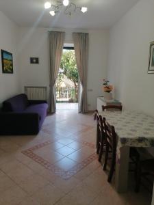 a living room with a table and a couch at Casa Anna in Cava deʼ Tirreni