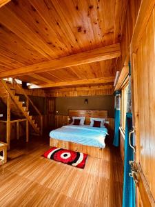 a bedroom with a bed in a wooden room at ThePahadians Food & Stay in Jibhi
