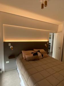 a bedroom with a bed with a light above it at AZUL - Pto Madryn in Puerto Madryn