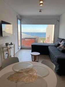 a living room with a couch and a table at AZUL - Pto Madryn in Puerto Madryn