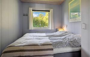 a bedroom with a bed and a window at 2 Bedroom Nice Home In Sydals in Neder Lysabild
