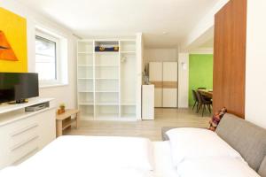 a living room with a white couch and a kitchen at Appartements Fam. Gleinser Mirella in Neustift im Stubaital