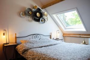 a bedroom with a large bed with a window at Domaine des Arches in Soumagne