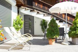a patio with a chair and a table and some plants at Appartements Fam. Gleinser Mirella in Neustift im Stubaital