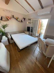 ein Wohnzimmer mit einem weißen Tisch und einem Sofa in der Unterkunft Romantic attic room with panoramic view in Bologna