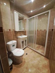 a bathroom with a toilet and a shower and a sink at Apartment 24, RYOR in Sunny Beach