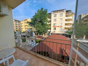 a balcony with a view of a street and buildings at Apartment 24, RYOR in Sunny Beach