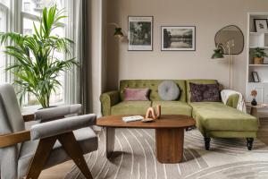 a living room with a couch and a table at Biskey Howe- Georgian Charm in Bowness-on-Windermere +20 photos