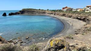 a beach with a group of people in the water at Studio Chaleureux au Cap d’Agde in Cap d'Agde