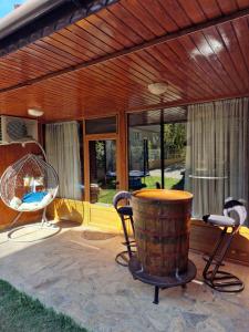 a patio with a table and chairs and a barrel at Rebeka Guest House in Tryavna