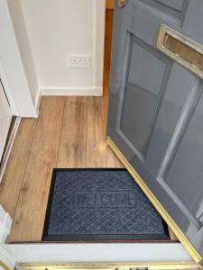 a door with a mop on the floor in a room at The Wee Hoose Rhu in Rhu