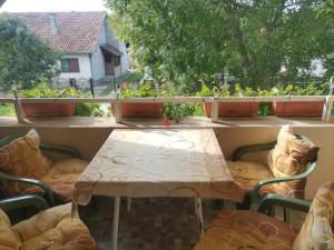 a table and chairs on a balcony with a table at Apartman Vera in Srbobran