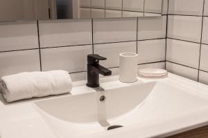 a bathroom sink with a faucet and a towel at BNBHolder Best II Madrid Rio in Madrid