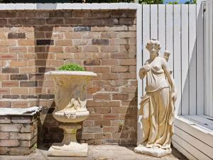 a statue of a woman standing next to a vase at VENUS Potts Point - FEMALE ONLY HOSTEL - Long stay negotiable in Sydney