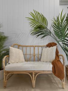 a wooden bench in a room with plants at VENUS Central Sydney - FEMALE ONLY HOSTEL in Sydney