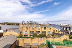 an apartment building with the city in the background at Stunning 1 bed flat in the heart of Greenwich in London
