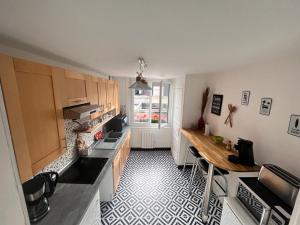 a kitchen with a counter and a table in it at Fenêtre sur mer in Le Portel