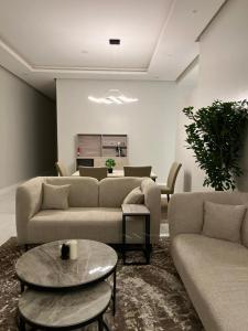 a living room with couches and a table at شقق مودرن مقابلة البوليفارد in Riyadh