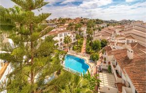 an aerial view of a building with a swimming pool and palm trees at 2 Bedroom Gorgeous Apartment In Málaga in Málaga