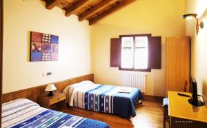 Postel nebo postele na pokoji v ubytování Hostal Musunzar