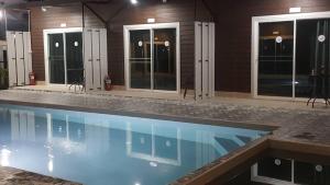 a swimming pool in front of a house at Lovely Paradise Phangan Hotel in Thong Sala