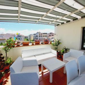 d'une terrasse avec mobilier blanc et vue sur la ville. dans l'établissement Terraced paradise, à Alghero