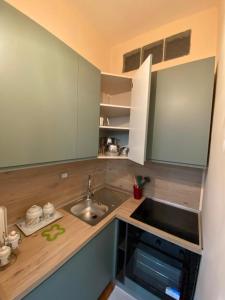 a kitchen with a sink and a counter top at PM 2 Via Scano Guest House A in Sassari