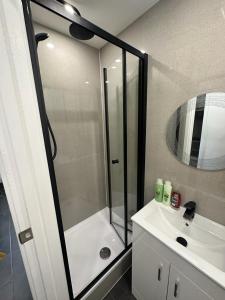 a bathroom with a shower and a sink at Modern flat in central Egham by Windsor Castle, Staines-Upon-Thames and Heathrow Airport in Egham