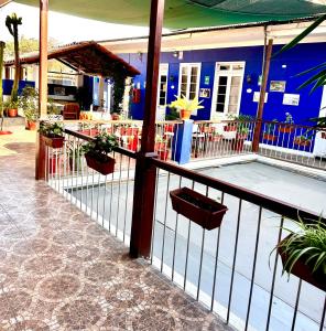 a balcony with potted plants and a blue building at Casona Jerusalen in Arequipa