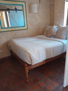 a bed with white sheets and pillows in a bedroom at Woodmere Serviced Apartment in Nairobi