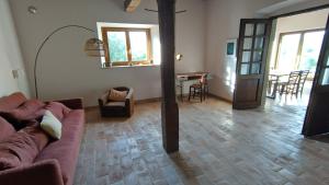 a living room with a couch and a table at Podere Cerrete - Eco Farmhouse in Castel del Piano