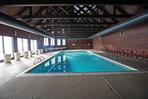 a large swimming pool in a building with chairs at Cascade Village 301 in Durango Mountain Resort