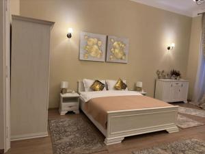 a bedroom with a large bed and two night stands at Studio Montaldo in Braşov