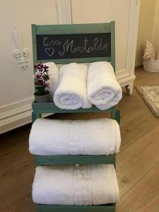 a stack of towels on a shelf in a bathroom at Studio Montaldo in Braşov