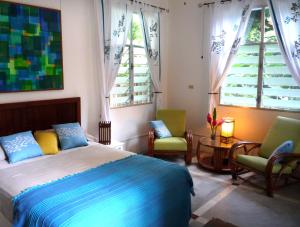 En eller flere senge i et værelse på Togo B&B Farallon