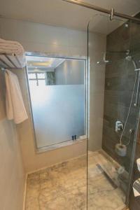 a bathroom with a shower with a glass door at Naama Bay Hotel & Resort in Sharm El Sheikh