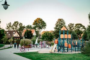 a park with a playground with a slide at Yacht Apartments in Wilkasy