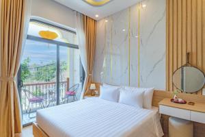 a hotel room with a bed and a balcony at Mint Hoi An Villa in Hoi An