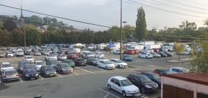 a parking lot filled with lots of parked cars at Cramiland - Appart complet chez nous in Montbéliard