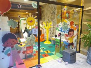 a childrens play room with a sliding glass door with childrens play equipment at Loft Praia Brava - Itajaí Camboriú piscina e playground in Itajaí