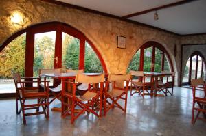 a dining room with tables and chairs and windows at Marina Park in Vama Veche