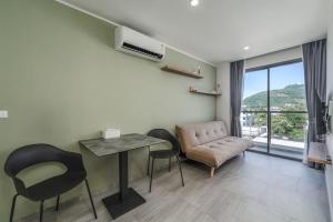 a living room with a table and chairs and a couch at New Condo,Great View,A* Location in Ban Klang