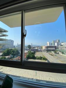 a view of a city from a window at Spacious Combine Family Unit Condo at Mesaverte Residences downtown near SM Gaisano Robinson and Centrio in Cagayan de Oro