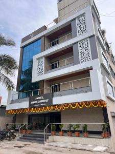 a tall building with a banner in front of it at Hotel Modi Samrat in Aurangabad