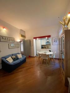 a living room with a blue bed and a table at PM 2 Via Scano Guest House B in Sassari