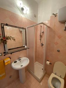 a bathroom with a shower and a sink and a toilet at PM 2 Via Scano Guest House B in Sassari