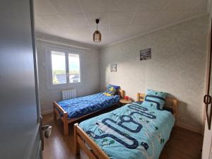 a bedroom with a twin bed and a window at Holiday Home in Binic near Sandy Beach in Binic-Etables-sur-Mer