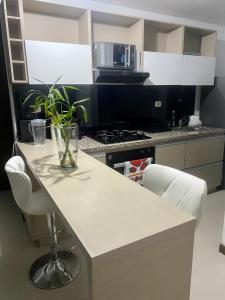 a kitchen with a table with a vase on it at Luxury apartment in Armenia