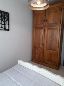 a bedroom with a bed and a wooden cabinet at Casinha CB in Casteição +28 photos